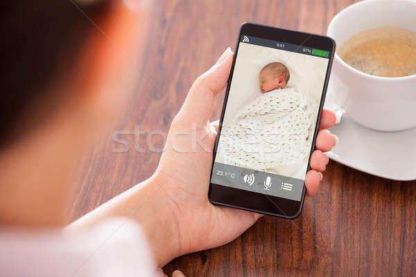 Person Hand Holding Babyphone Stock photo © AndreyPopov