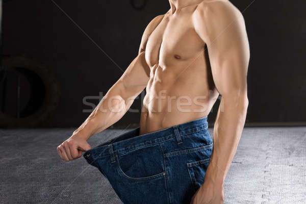 Close-up Of A Man Wearing Loose Jean Stock photo © AndreyPopov