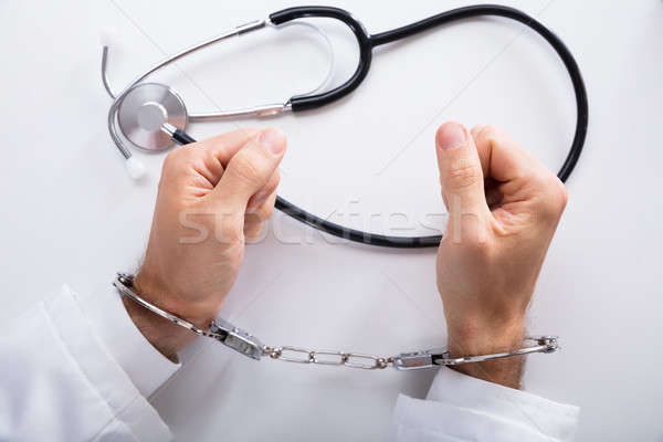 Elevated View Of Arrested Doctor's Hand And Stethoscope Stock photo © AndreyPopov