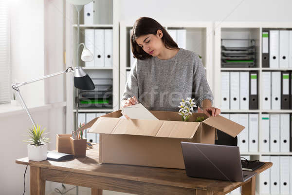 Businesswoman Packing Her Belongings In Cardboard Box Stock photo © AndreyPopov