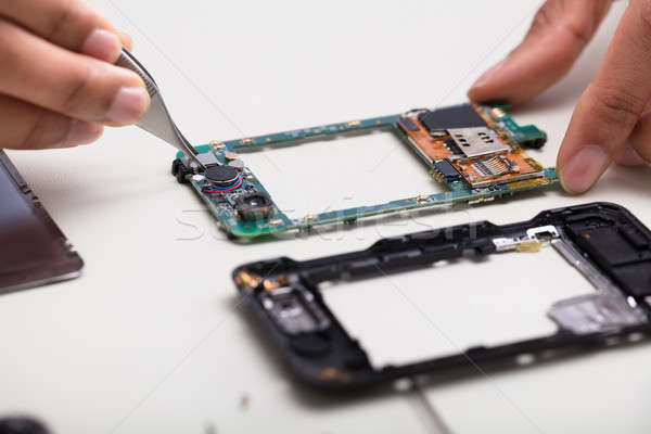 Technician Repairing Damaged Smartphone Stock photo © AndreyPopov