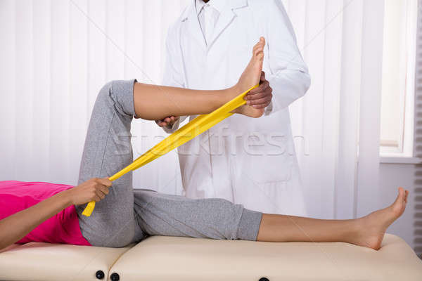 Female Patient Using Ribbon While Doing Exercise Stock photo © AndreyPopov