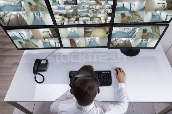Security Guard Monitoring Multiple Camera Footage On Computer Stock photo © AndreyPopov