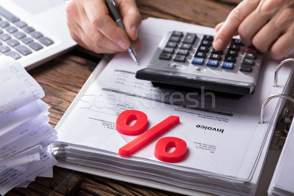Businessperson's Hand Calculating Bill With Calculator Stock photo © AndreyPopov