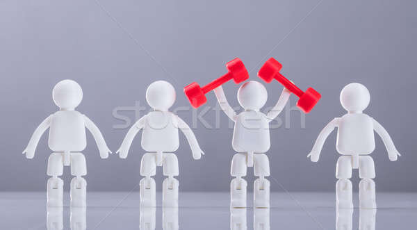 Human Figures Exercising With Red Dumbbells Stock photo © AndreyPopov