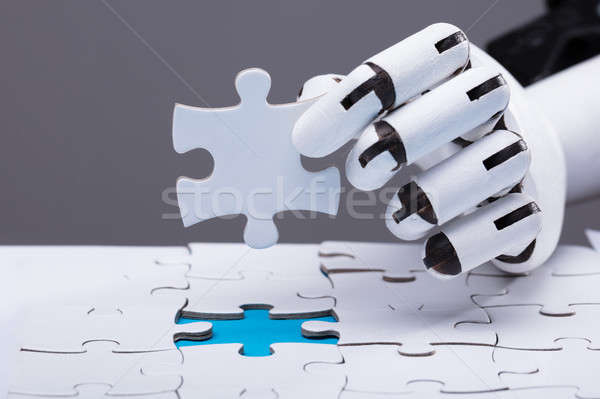 Robot Solving Jigsaw Puzzle Stock photo © AndreyPopov