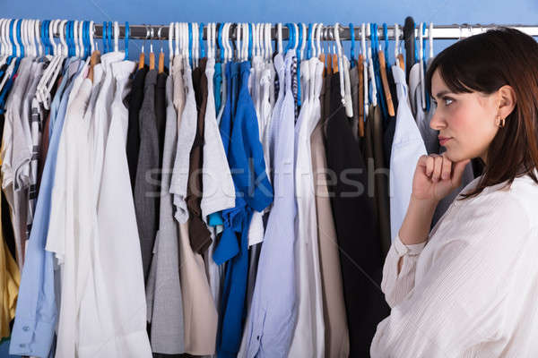 Woman Looking At Clothes On Clothes Rail Stock photo © AndreyPopov