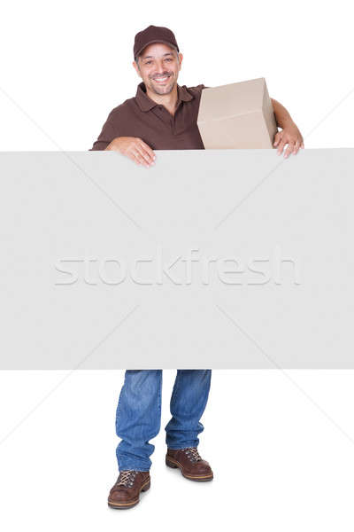 Happy Delivery Man Holding Cardbox And Placard Stock photo © AndreyPopov