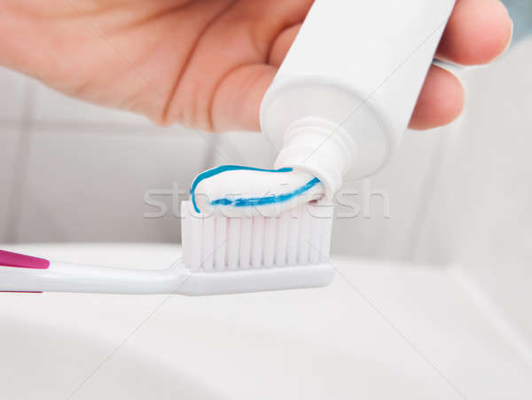 Hand holding a tooth brush with paste Stock photo © AndreyPopov