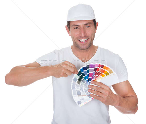 Stock photo: Painter Holding A Paint Roller And Spectrum