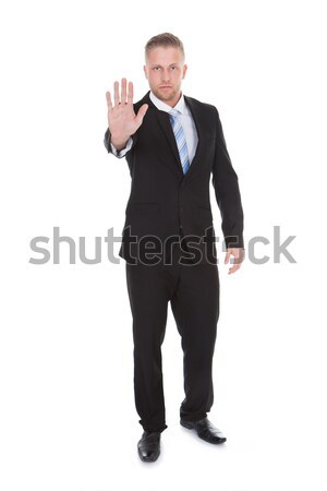 Businessman holding up his hand in a stop gesture Stock photo © AndreyPopov