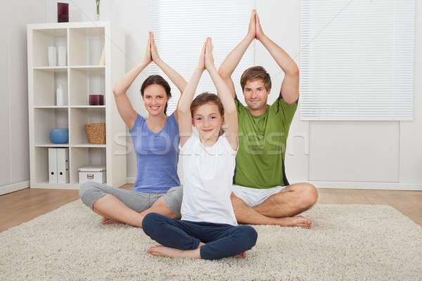 Family Practicing Yoga On Rug Stock photo © AndreyPopov