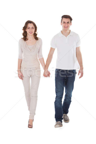 Couple In Casuals Walking Over White Background Stock photo © AndreyPopov