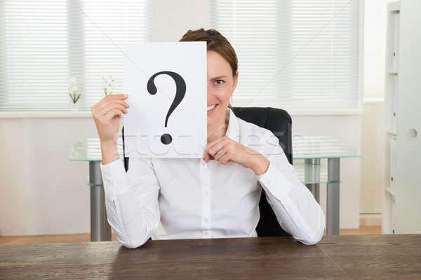 Businesswoman Showing Question Mark On Paper Stock photo © AndreyPopov