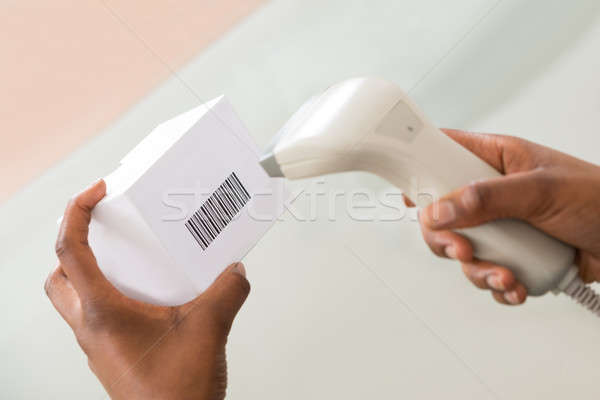 Person's Hand Scanning Barcode With Barcode Scanner Stock photo © AndreyPopov