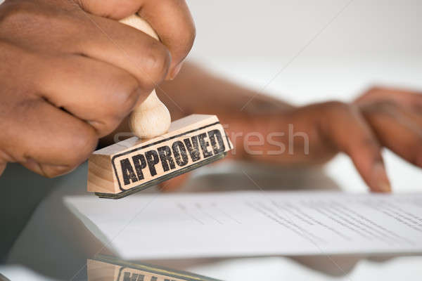 Person's Hand Stamping On Contract Form Stock photo © AndreyPopov