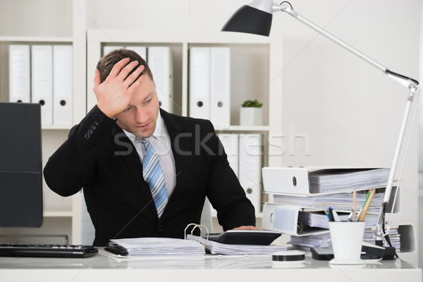 Tensed Accountant Sitting At Desk In Office Stock photo © AndreyPopov