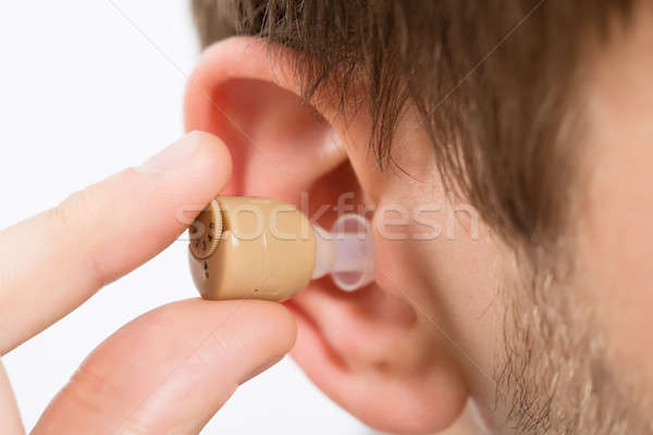 Homme prothèse auditive oreille jeune homme Photo stock © AndreyPopov