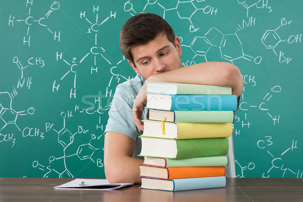 Stock photo: Sad Man Leaning On Stack Of Books