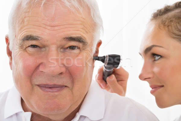 Female Doctor Examining Patient's Ear Stock photo © AndreyPopov