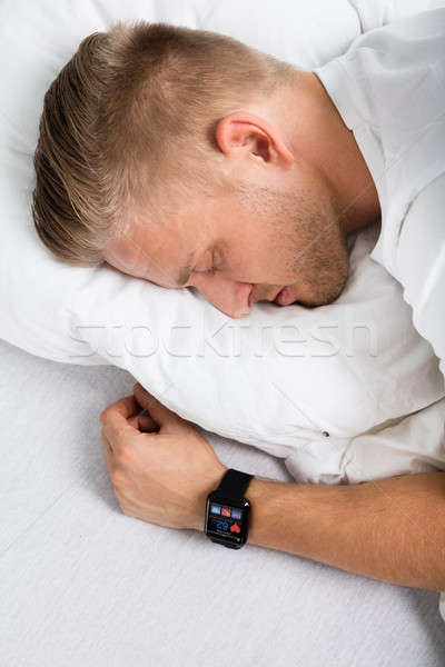 Man Sleeping With Smart Watch In His Hand Stock photo © AndreyPopov