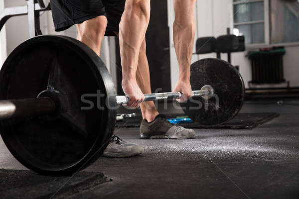 Stock photo: Fitness Man With Weights Doing Exercises