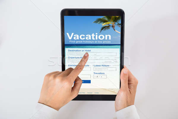 Businessperson Filling Online Vacation Form On Digital Tablet Stock photo © AndreyPopov