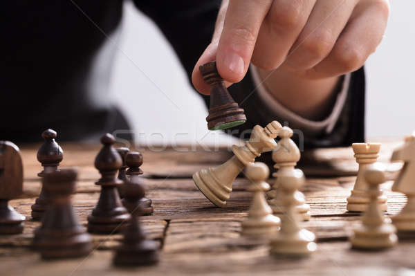Businessperson Checkmating King Chess Piece With Rook Stock photo © AndreyPopov