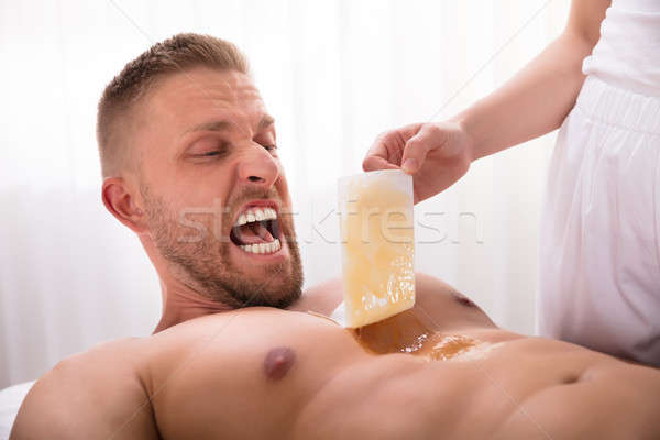 Stock photo: Beautician Waxing Man's Chest