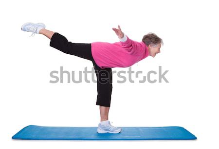 Senior Woman Standing On One Leg And Exercising Stock photo © AndreyPopov