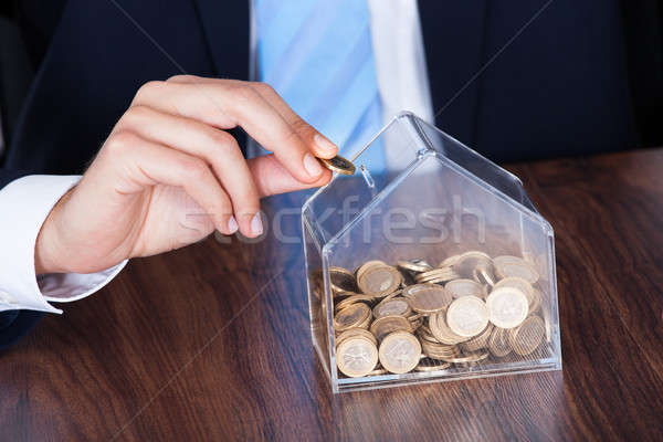 Businessman Inserting Coin In Box Stock photo © AndreyPopov