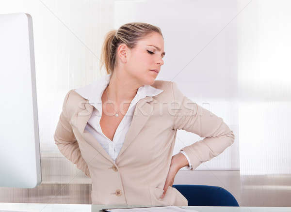 Jonge zakenvrouw lijden rugpijn kantoor computer Stockfoto © AndreyPopov