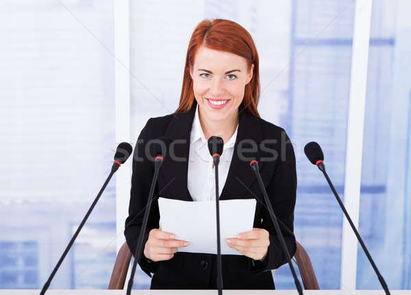 Uśmiechnięty kobieta interesu mowy konferencji młodych wielokrotność Zdjęcia stock © AndreyPopov