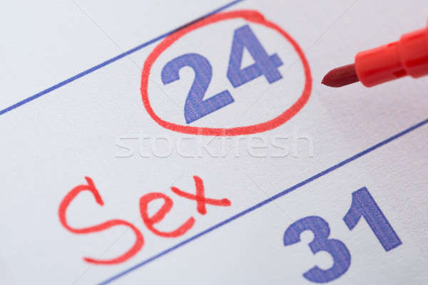 Fecha sexo calendario primer plano rojo pluma Foto stock © AndreyPopov