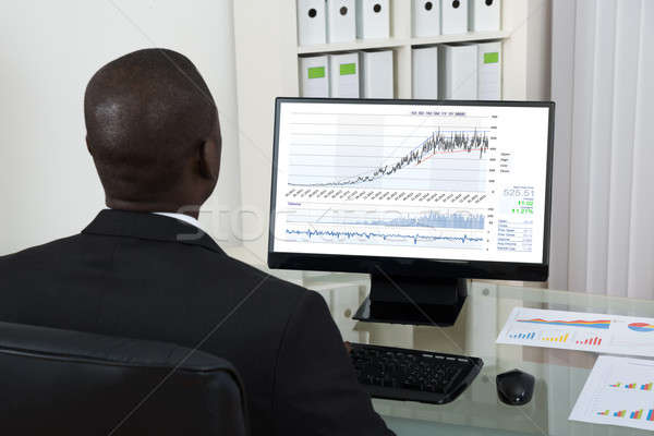 Businessman Looking At Graph On Computer Stock photo © AndreyPopov