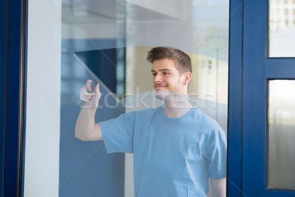Worker Cleaning Glass With Squeegee Stock photo © AndreyPopov