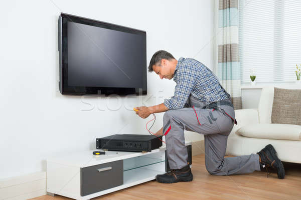 Technician Installing TV Set Top Box At Home Stock photo © AndreyPopov