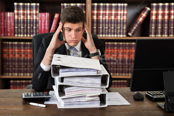 Stressed Attorney Looking At Heap Of Binders Stock photo © AndreyPopov