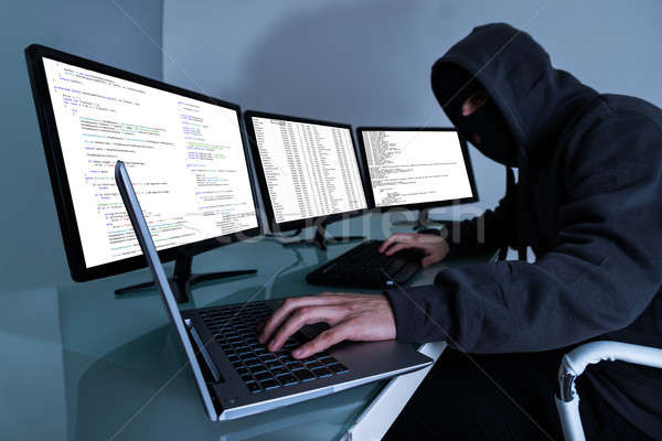 Hacker Stealing Data On Multiple Computers Stock photo © AndreyPopov