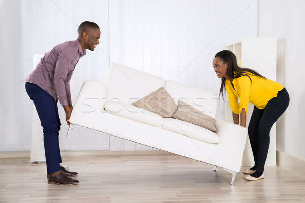 Couple Placing Sofa In Living Room Stock photo © AndreyPopov