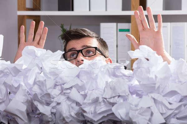 Close-up Of Businessman Behind Heap Of Crumpled Paper Stock photo © AndreyPopov