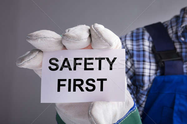 Workman Showing Safety First Sign Stock photo © AndreyPopov