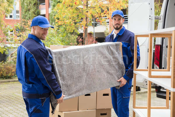 Two Male Worker Unloading Furniture From Truck Stock photo © AndreyPopov