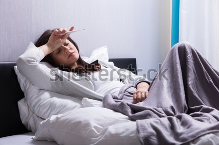 Kobieta cierpienie żołądka ból młoda kobieta bed Zdjęcia stock © AndreyPopov