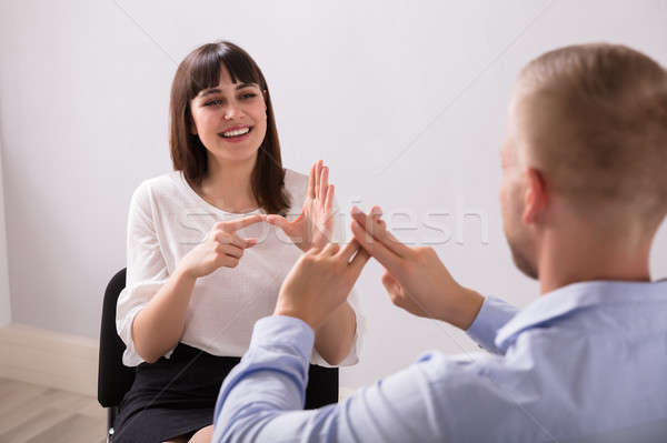 Stock photo: Young Woman And Man Talking With Sign Language