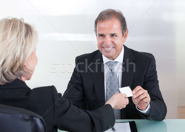 Businesspeople Exchanging Visiting Card In Office Stock photo © AndreyPopov