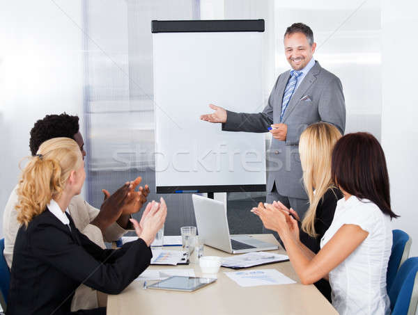 Businesspeople Clapping For A Man In Meeting Stock photo © AndreyPopov
