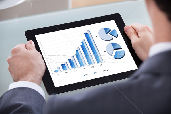 Businessman Analyzing Chart On Digital Tablet Stock photo © AndreyPopov