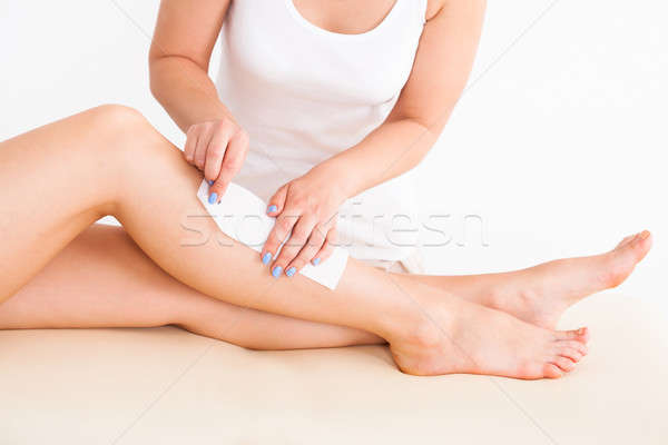 Femminile terapeuta ceretta clienti gamba Foto d'archivio © AndreyPopov