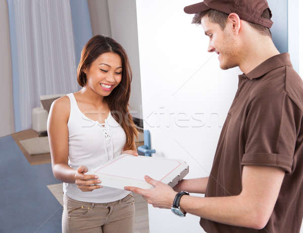 Woman Receiving Pizza From Delivery Man Stock photo © AndreyPopov